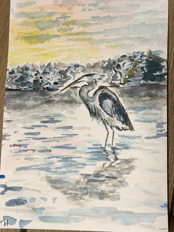 Watercolour of a heron wading in open water at sunset, a pale yellow sky above a dark treeline.