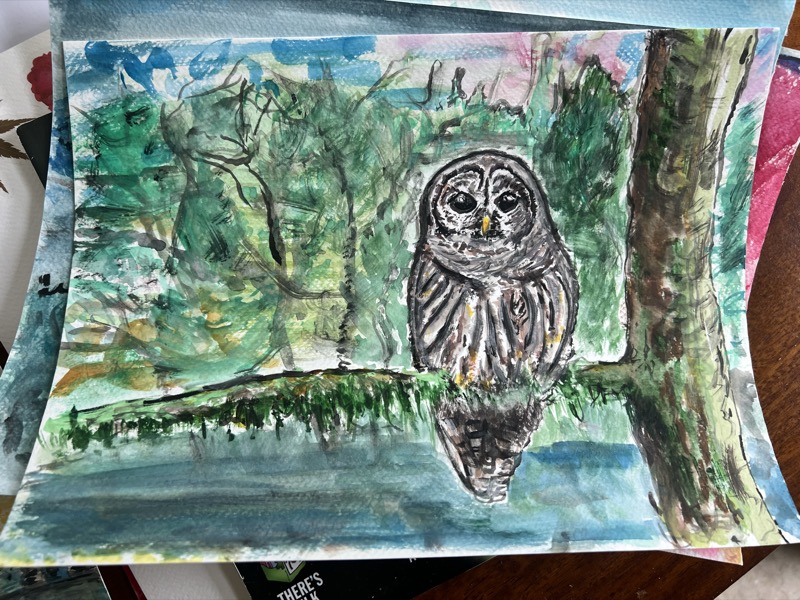 Watercolour of an owl in the hollow of a tree trunk, green woodland around it.
