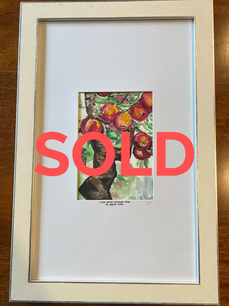 A small framed watercolour of apples on a branch, marked sold