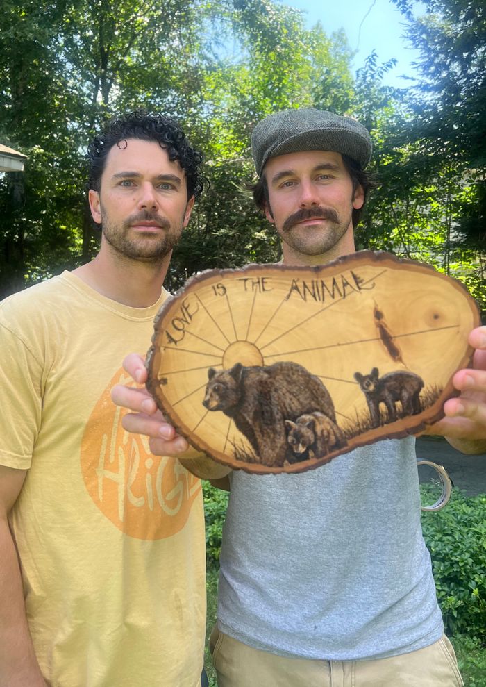 The two of us holding up the wood burning outdoors